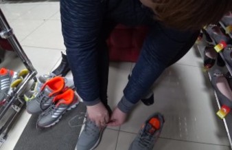 Foot fetish in a public shoe store. Fat legs try on sneakers.