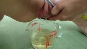 pee in measuring cup | close up