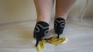Fat legs in heeled shoes mercilessly trampled a banana. Crush Fetish.