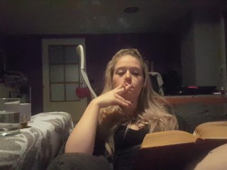 reading a book and smoking cigarette