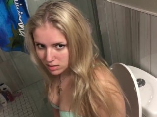 Cute teen face close up while peeing on toilet