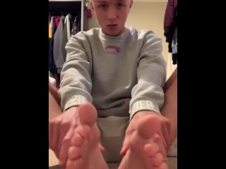 Blonde twink strips to underwear and massages feet