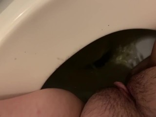 Teen girl peeing in toilet