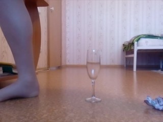 Crossdresser urinates in a glass of champagne