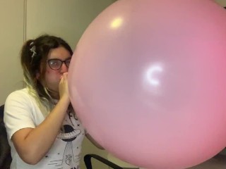 Cute pink balloon popped by blowing hard in it