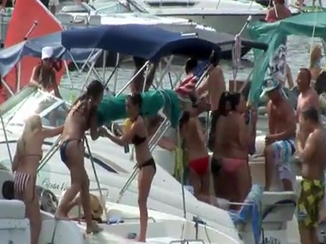 Horny babes have fun on some boats